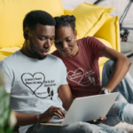 The-Book-of-Proverbs-couple-with-a-laptop-computer-wearing-t-shirts-with-Proverbs-verses