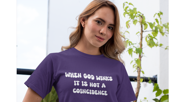 a woman in a purple shirt with When God Winks lettering